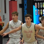 Boy's basketball players blocking