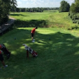 Male golfer lining up to hit the ball