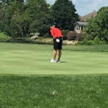 Male golfer lining up to hit the ball