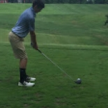 Male golfer lining up to hit the ball