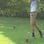 Male golfer swinging club