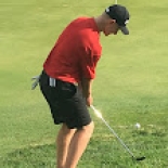 Male golfer lining up shot