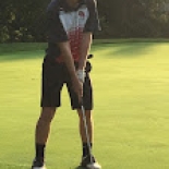 Male golfer lining up shot