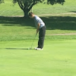 Male golfer lining up shot