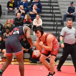 wresters on mat squaring up