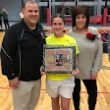 Girl's basketball player holding award