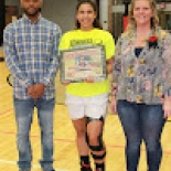 Girl's basketball player holding award