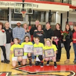 Girl's basketball players holding awards