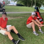 golfers sitting in grass