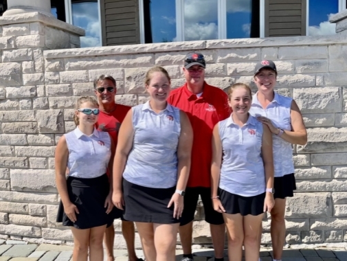 girls golf players with coaches