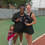 Two tennis players smiling with awards