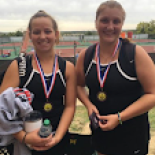 Two tennis players smiling with awards