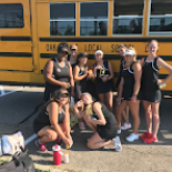Tennis team in front of bus